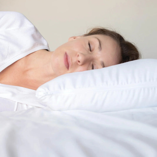A chiropractor-recommeded pillow provides perfect support for the lady while sleeping on her side