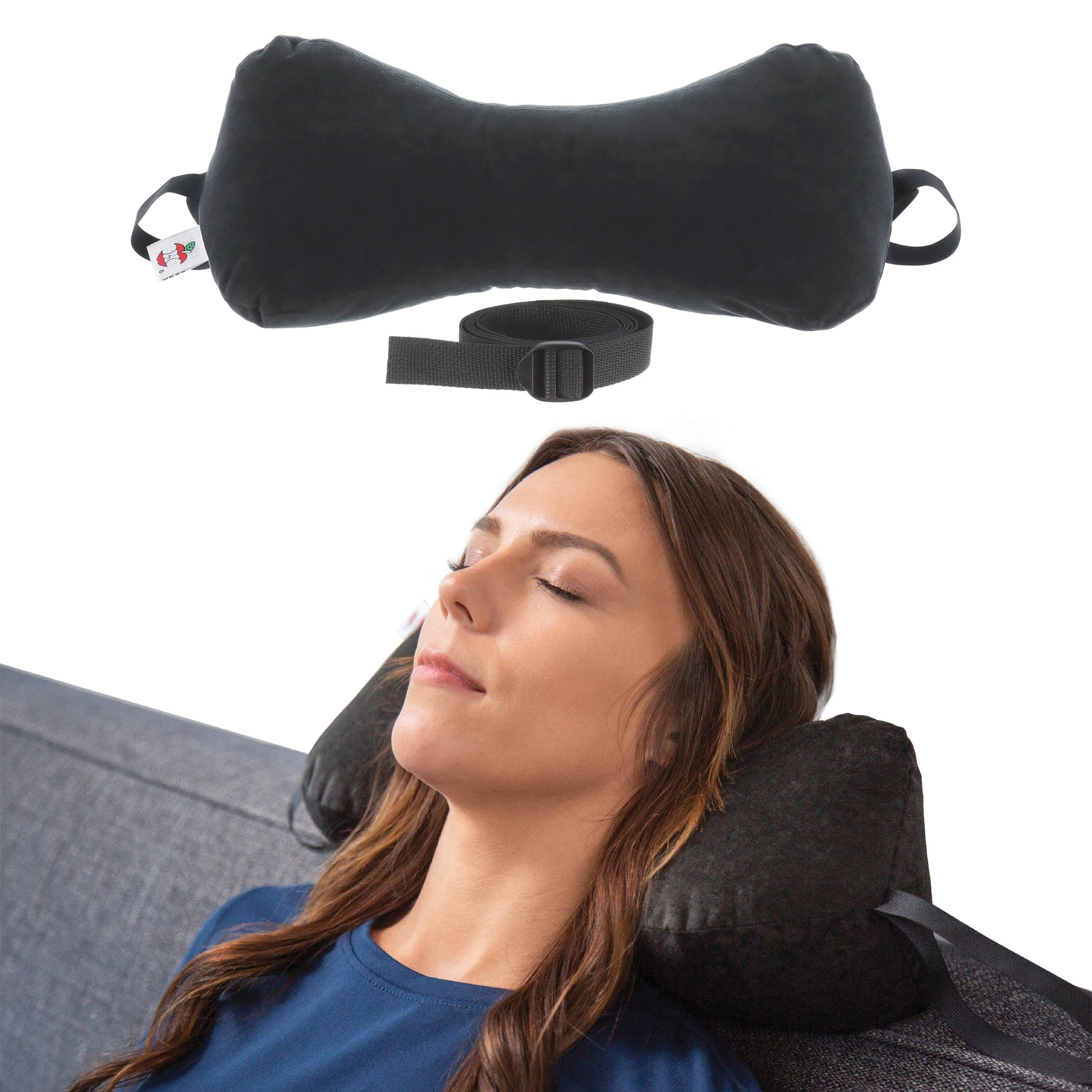 Adjustable neck support pillow with positioning strap shown supporting the neck while resting on a sofa