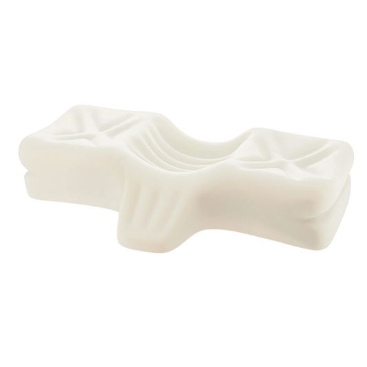 Close-up view of a contoured chiropractic pillow made from resilient molded foam, designed with ergonomic grooves to support natural neck and head alignment for pain relief.